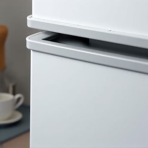 A general inspection of a Sub-Zero appliance by a technician wearing gloves, demonstrating attention to detail and care during the repair process.